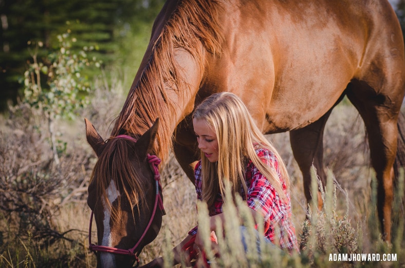 Jackson Hole Senior Photo of Girl Kneeling with Horse