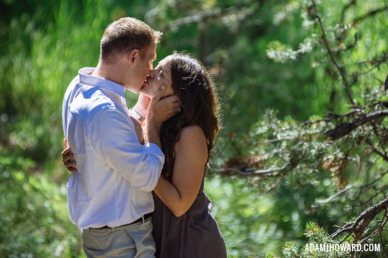 Engaged Couple Kissing in the Forest