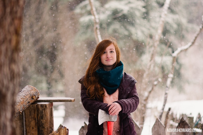 Beautiful Girl with Ax in the Snow