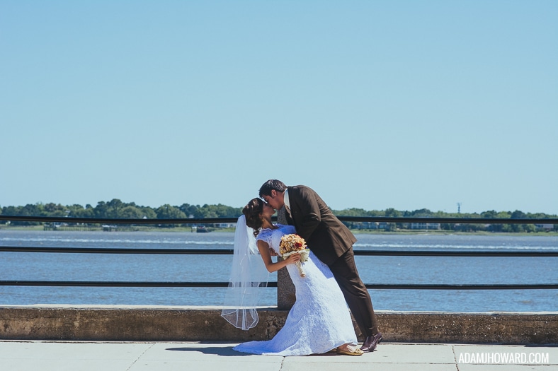 couple dipping in front of the charleston battery harbor