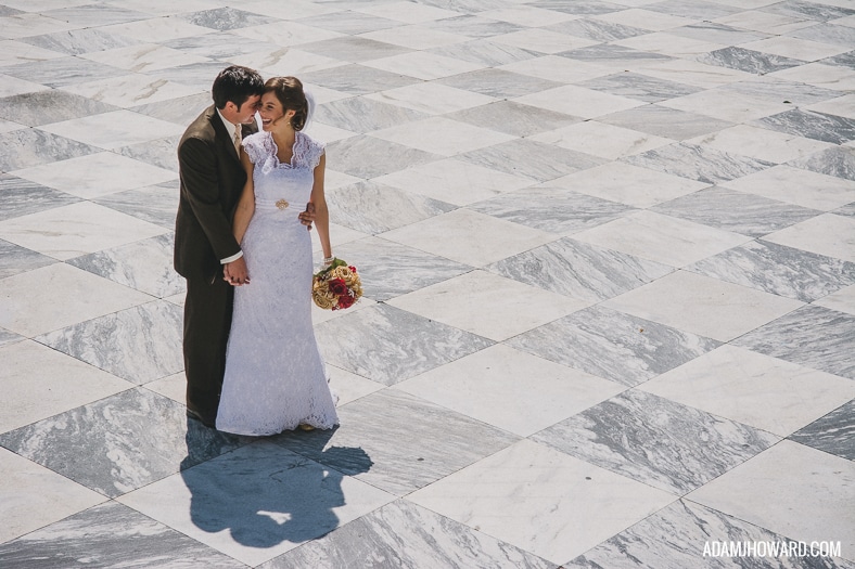 wedding portrait of couple in front of charleston customs house