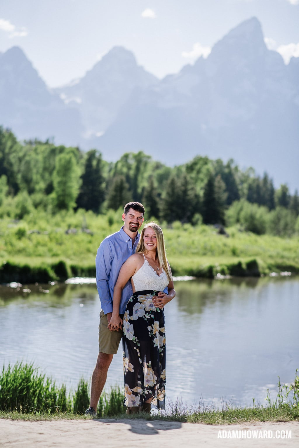Happy couple hugging in front of the Tetons in the Summer